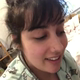 A very cute girl squats and pees into a clear cup. Peeing only. Filmed from a POV perspective. Vertical format video. About a minute.